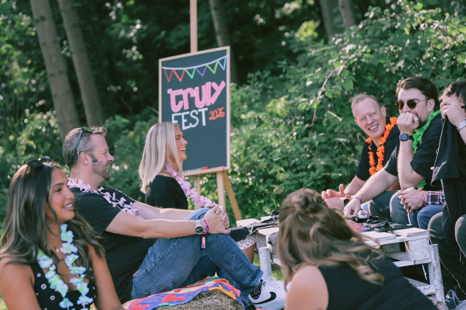 Guests laughing by the Truly Fest sign