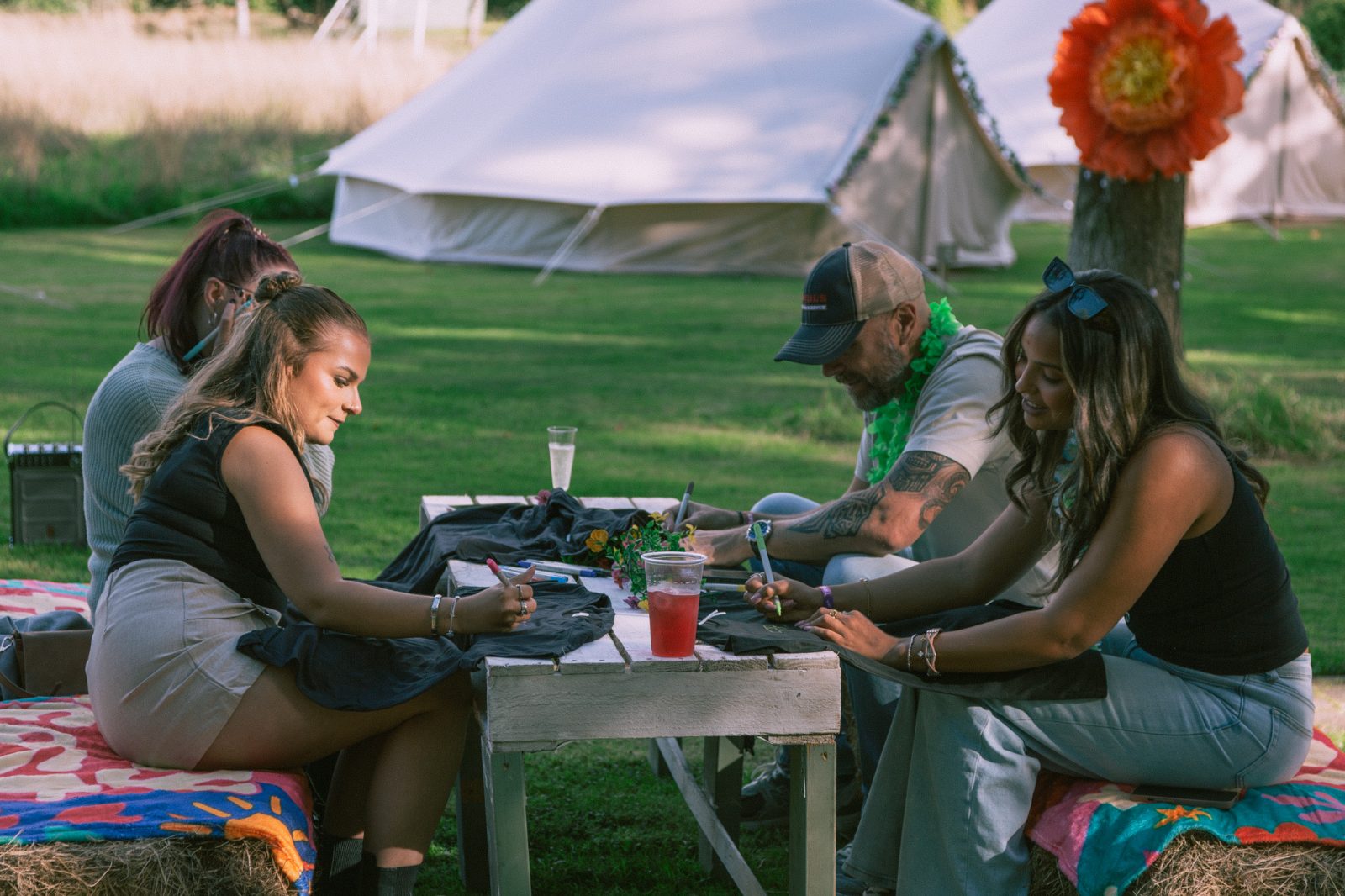 T-shirt design activity by the bell tents
