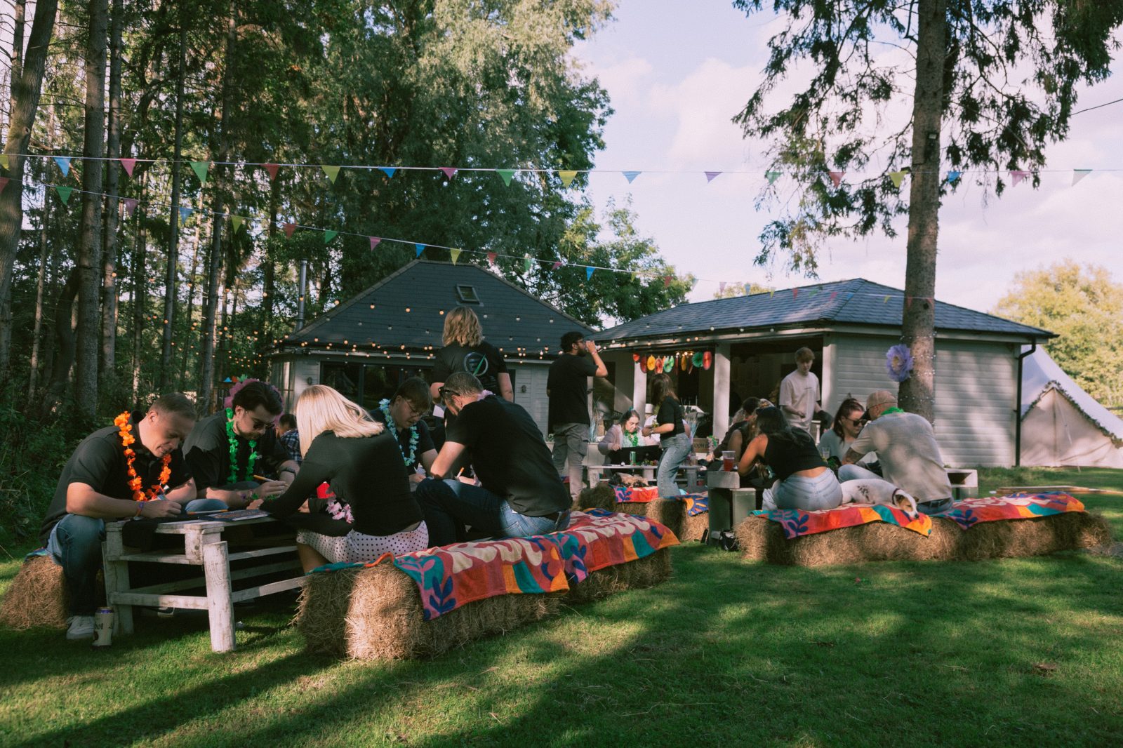Guests on decorated hay bale seating outside the lodge