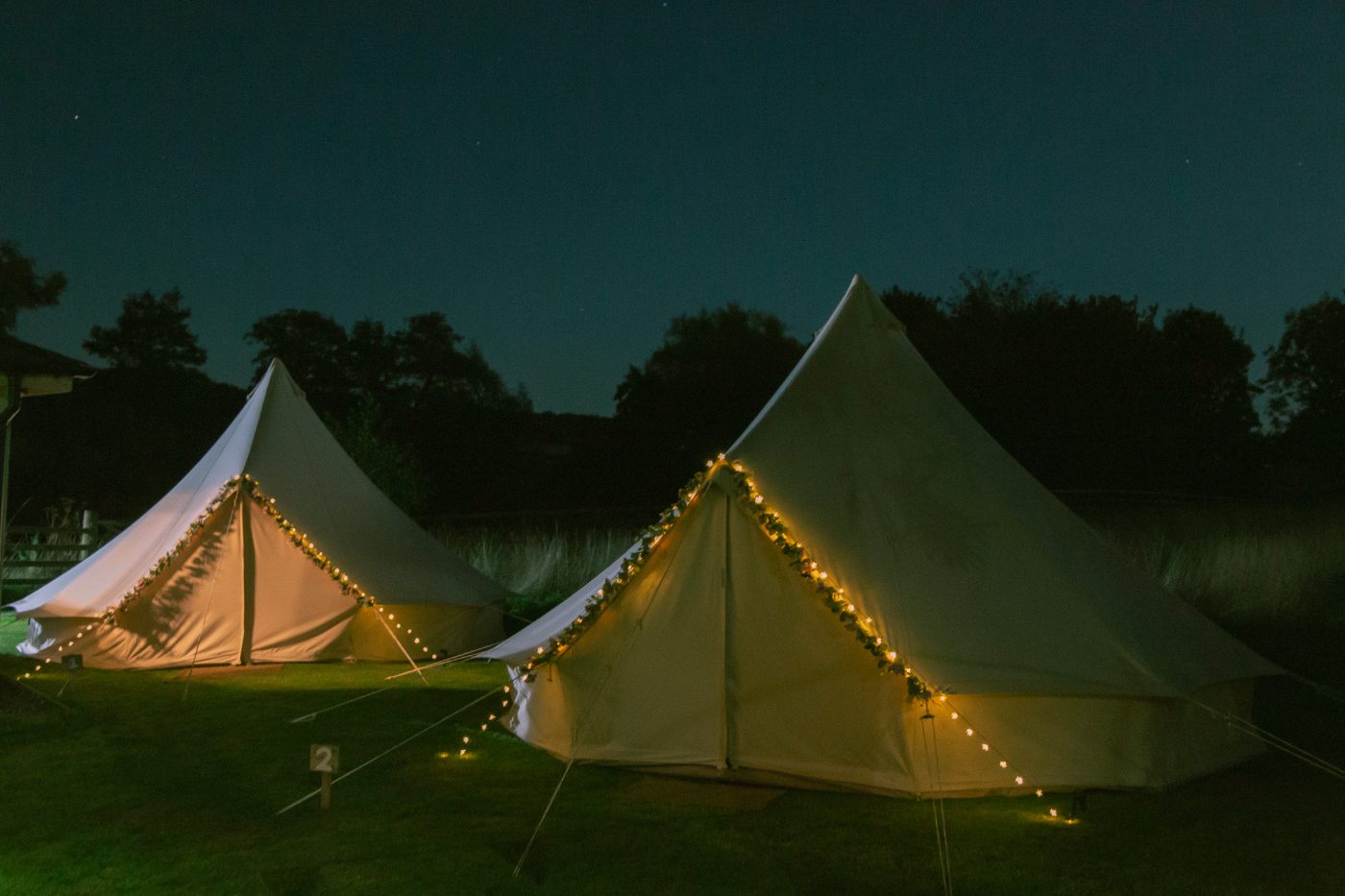 Bell tents lit up at night